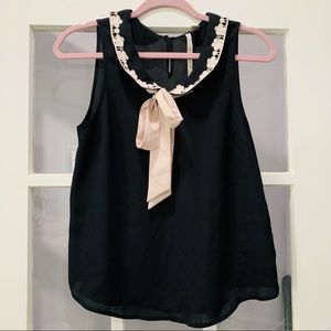 Black, cream and beige sleeveless blouse